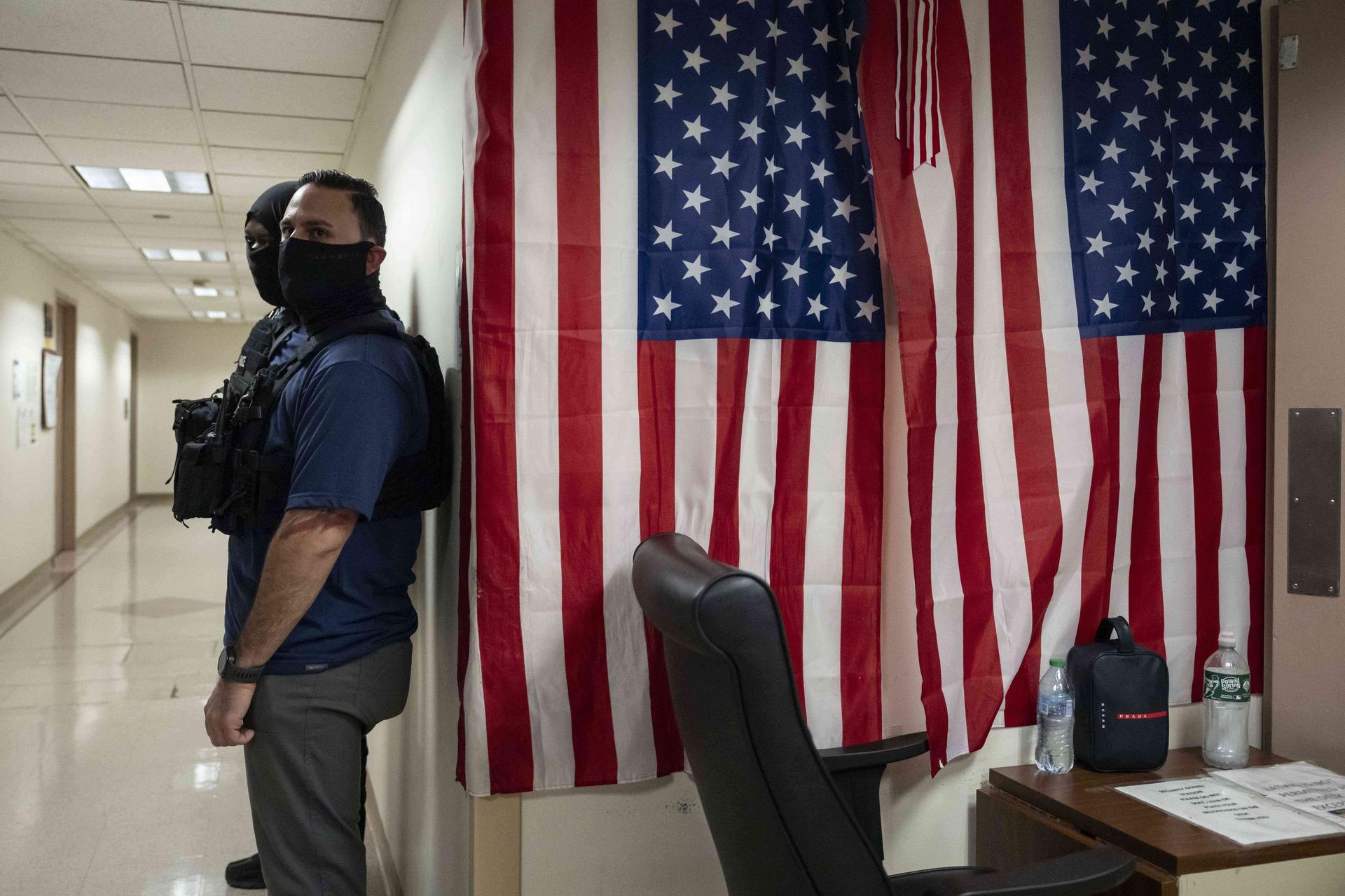 Federal agents stand outside an immigration court at the Jacob K. Javits federal building in New York, in September.