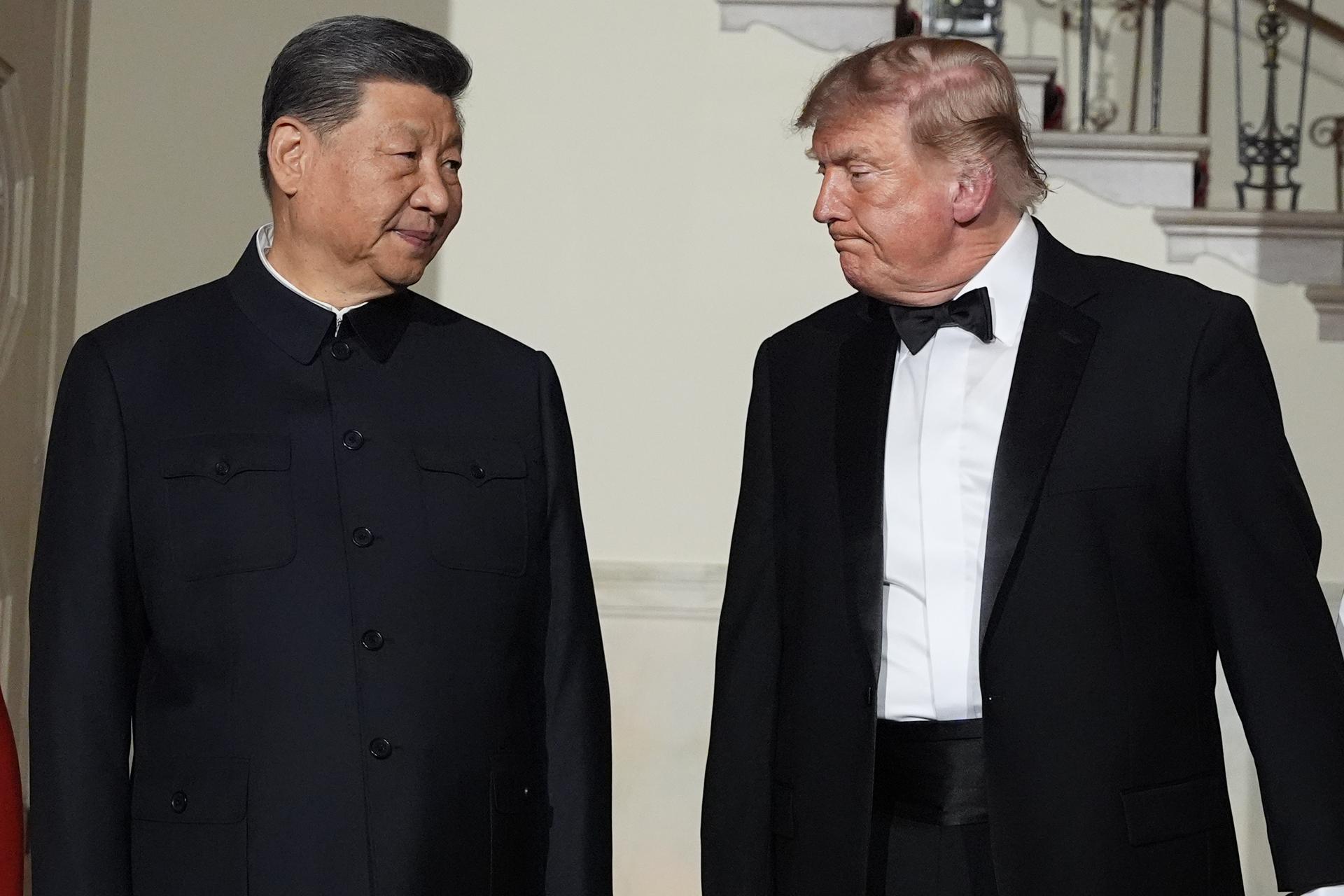 China’s President Xi Jinping and President Donald Trump walk in the Grand Foyer of the White House during a State Dinner on Thursday in Washington.