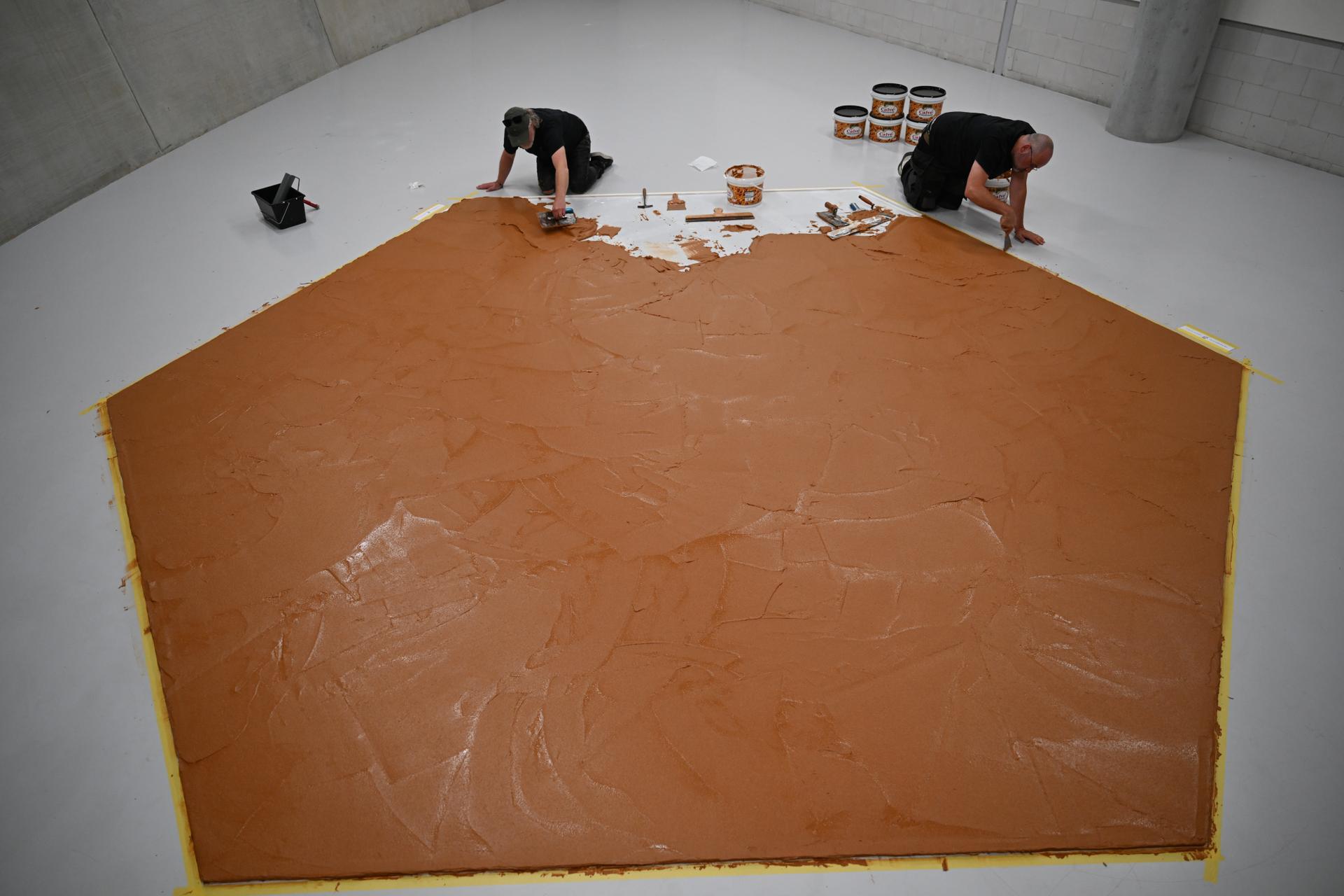 Workers spread peanut butter on a floor at the Museum Boijmans Van Beuningen in Rotterdam, the Netherlands, July 3.