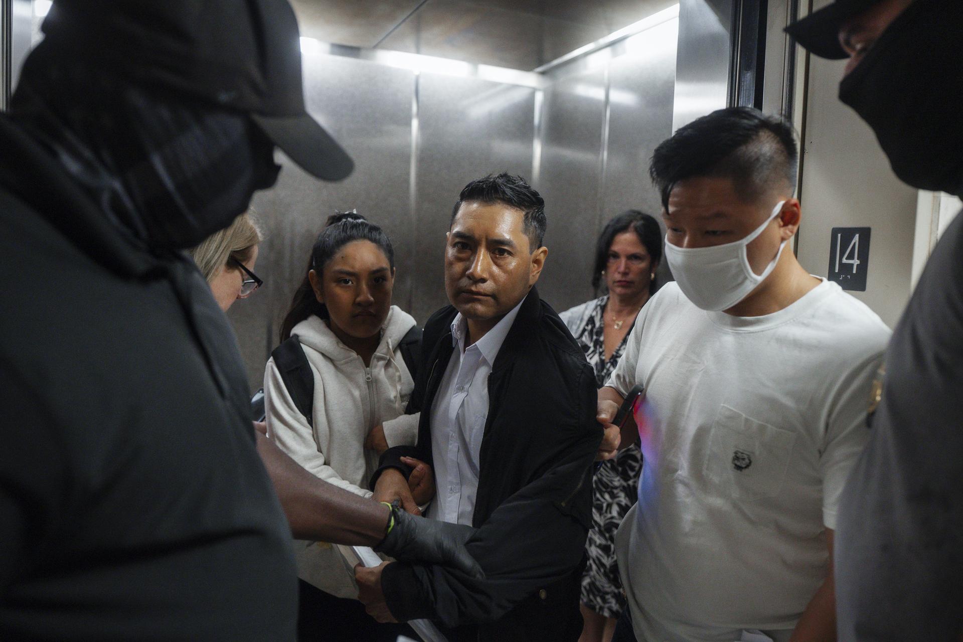 Immigration and Customs Enforcement agents pull a man out of an elevator as he and his daughter attempt to leave following a hearing in immigration court in New York in September. (AP Photo/Olga Fedorova)
