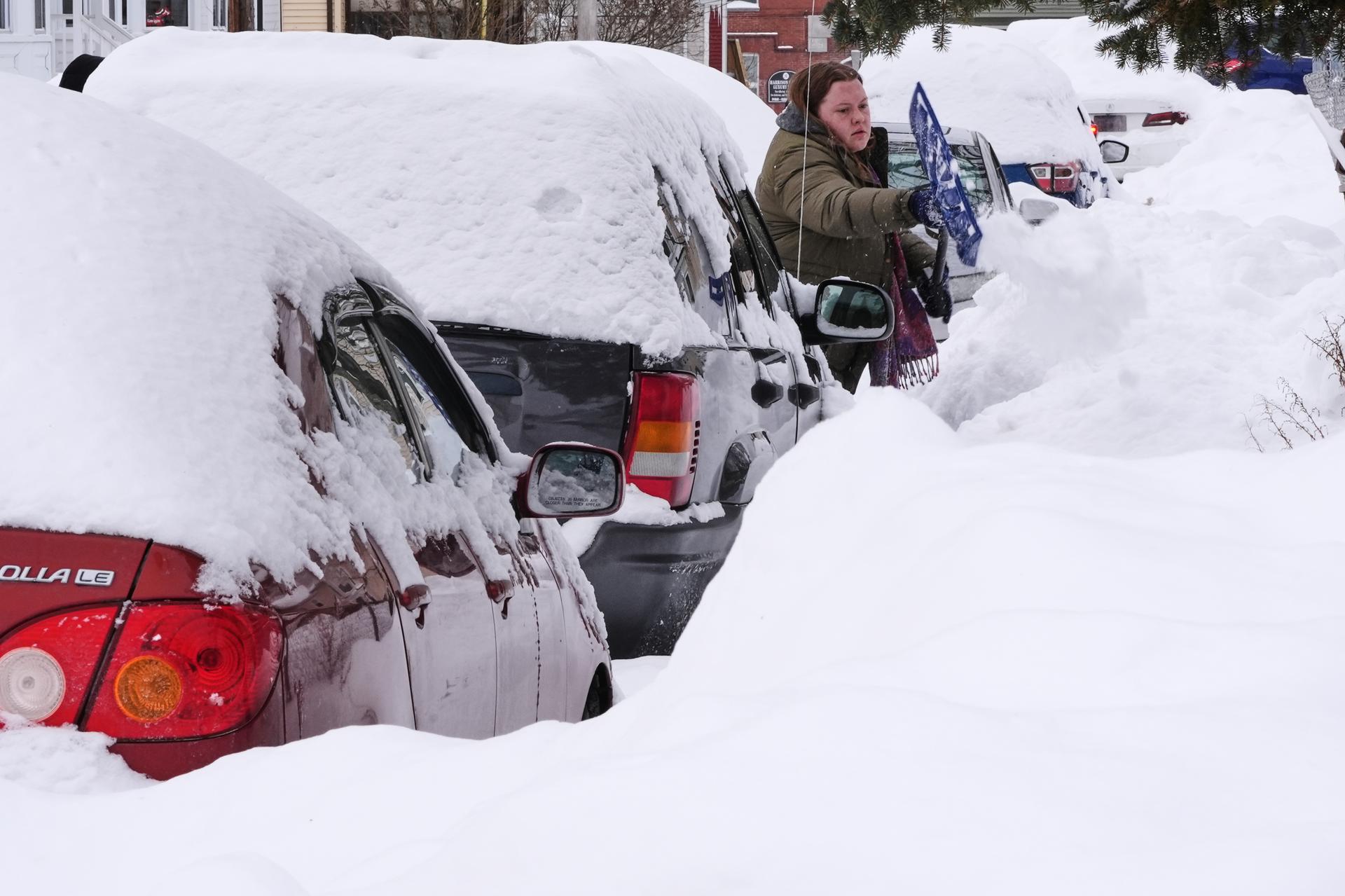 Emma Teske shovels out her car in Haverhill, Mass., on Tuesday. (AP Photo/Charles Krupa)