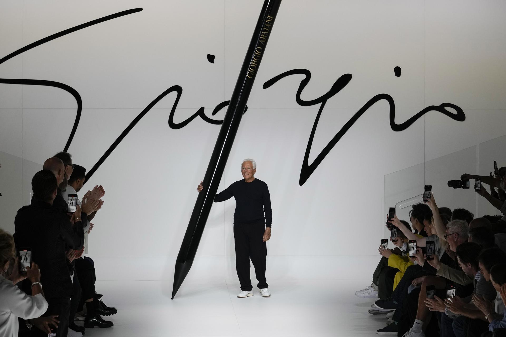 Designer Giorgio Armani receives applause at the end of the Giorgio Armani men's Spring Summer 2024 fashion show in 2023. (AP Photo/Luca Bruno, File).
