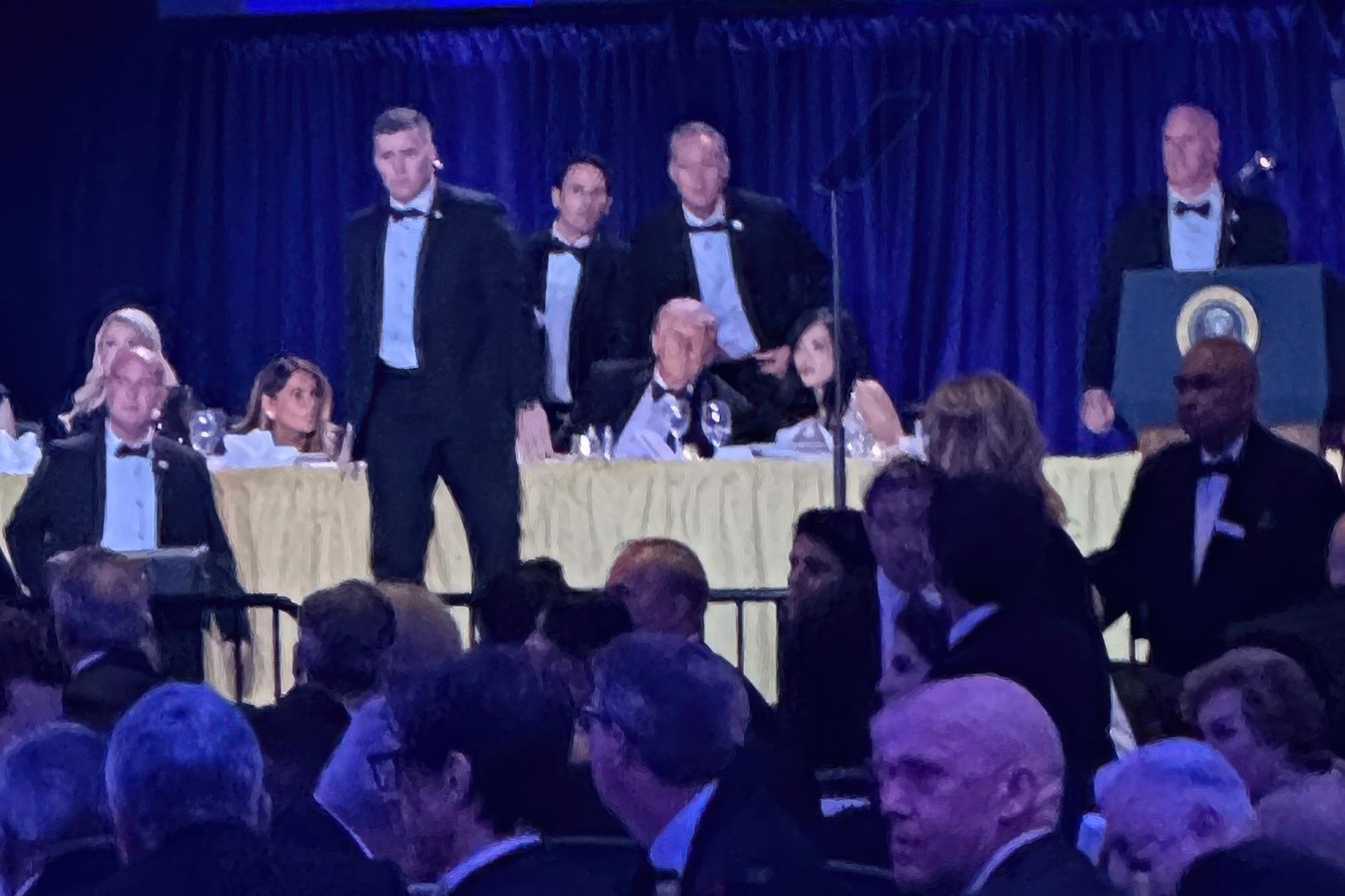 U.S. Secret Service agents surround President Donald Trump before he was taken from the stage after a shooting incident outside the ballroom during the White House Correspondents Dinner on Saturday. (AP Photo/Alex Brandon)
