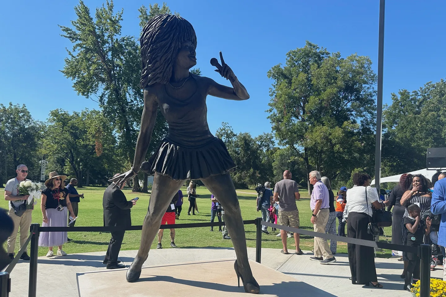 A statue of Tina Turner singing, with giant hair holding a microphone
