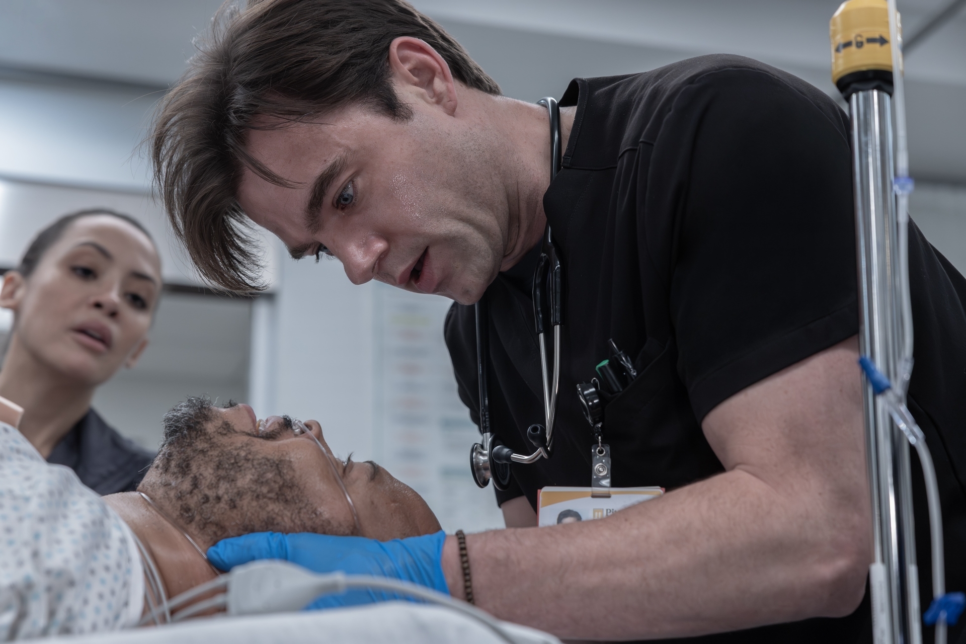 Dr. Frank Langdon (Patrick Ball) treats a patient on The Pitt.