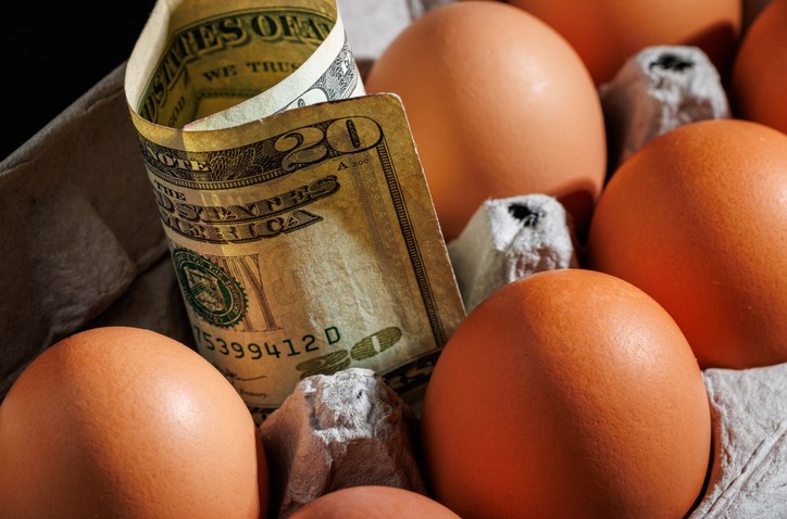 eggs in a carton with a $20 bill in one of the egg spots