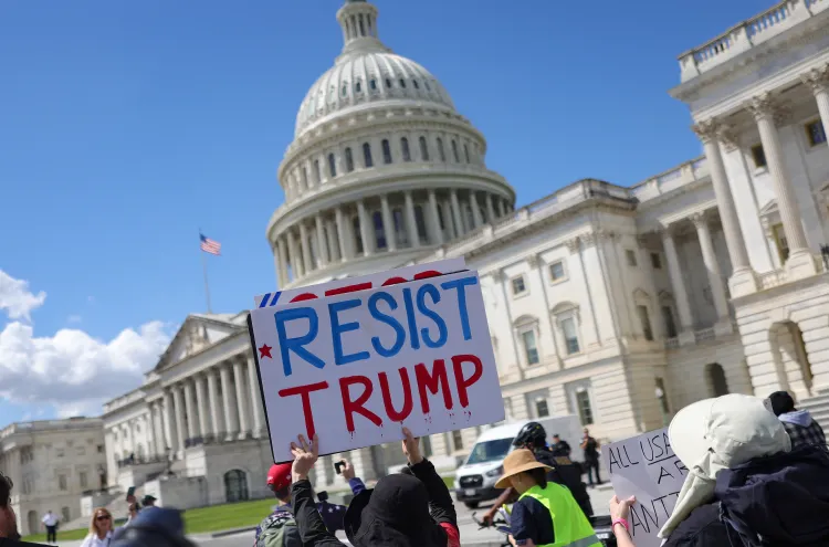 People protest President Donald Trump outside of the US Capitol.