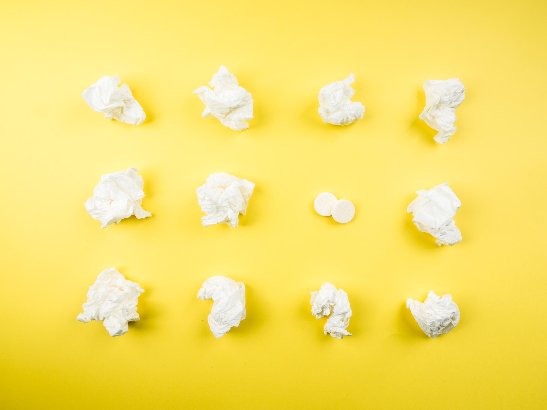 Wads of tissues against a yellow background