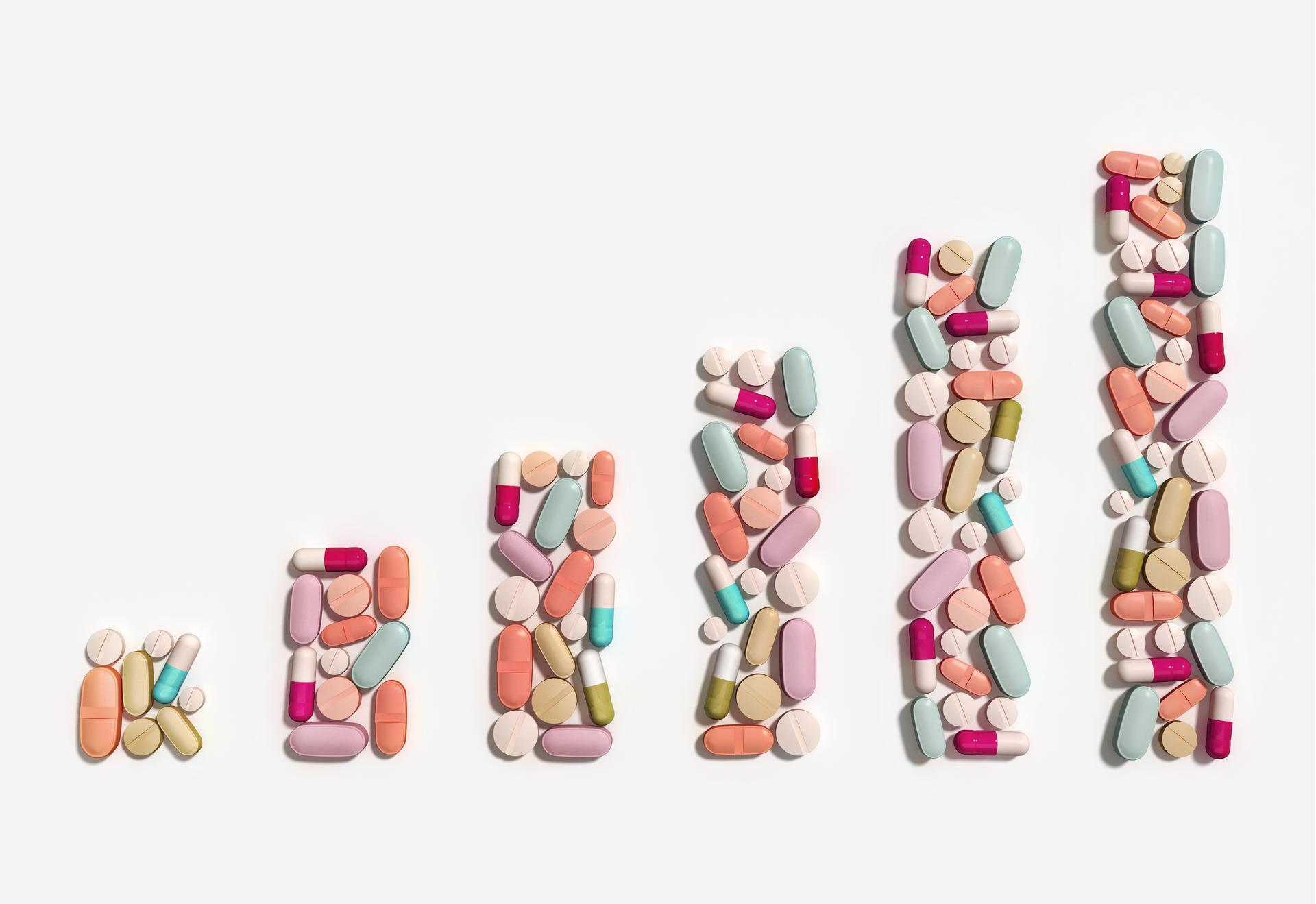 Growing stacks of pills represent rising health care costs.
