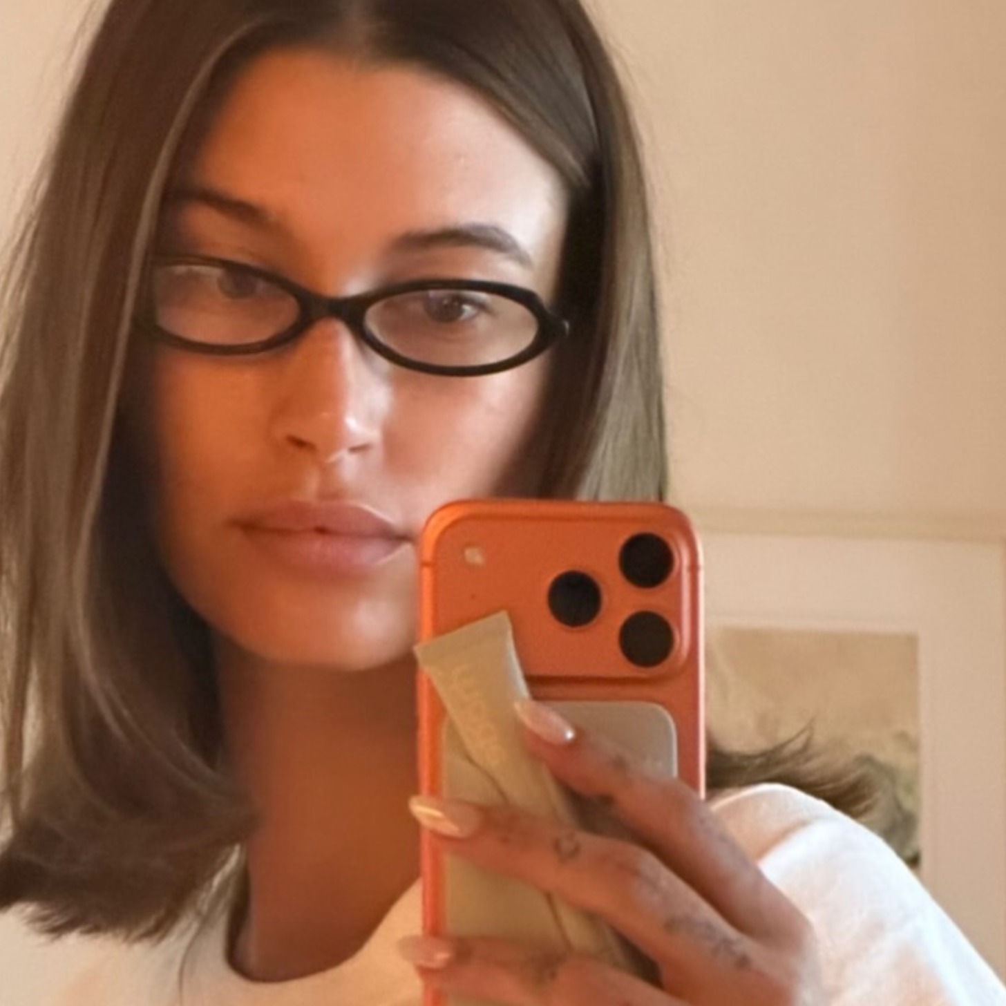 Hailey BIeber posing with black glasses.