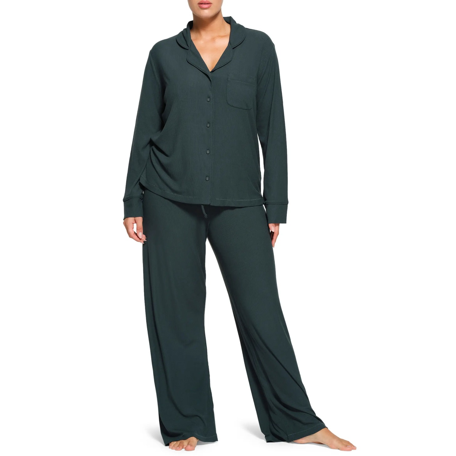 Model wearing a green button down pajama set.