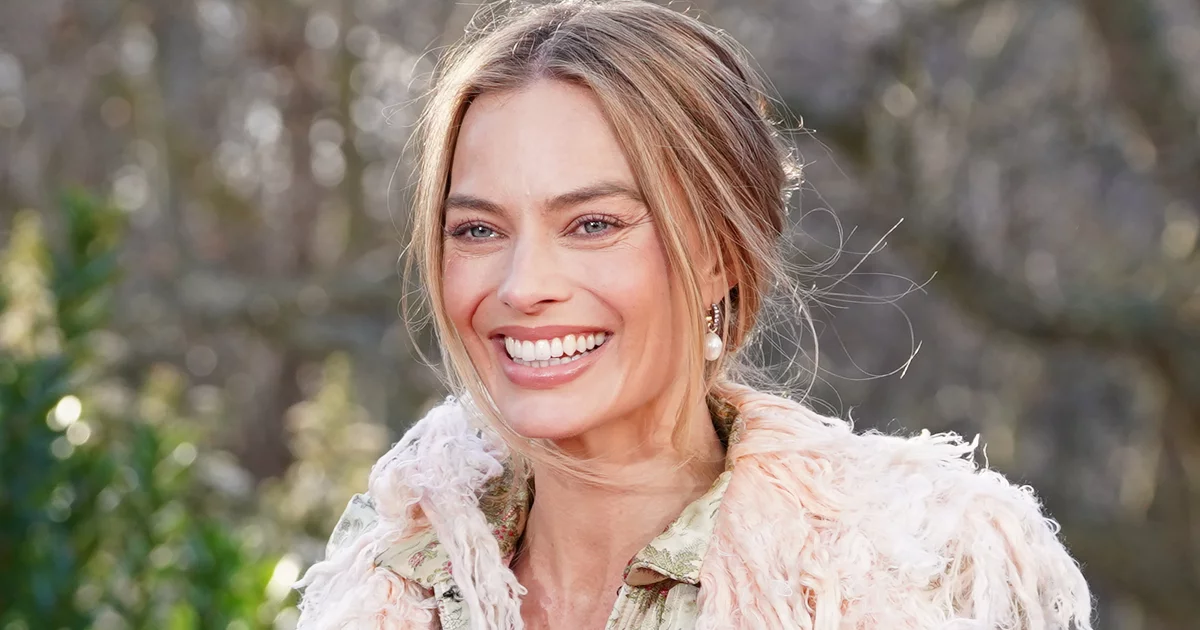 Margot Robbie's smiling.