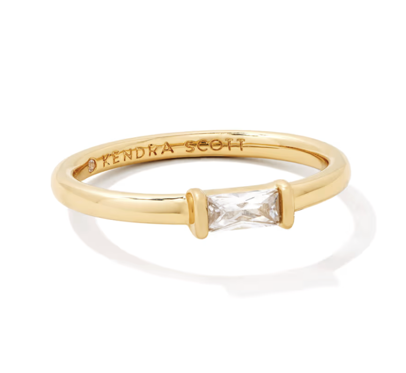 Gold ring with white crystal.