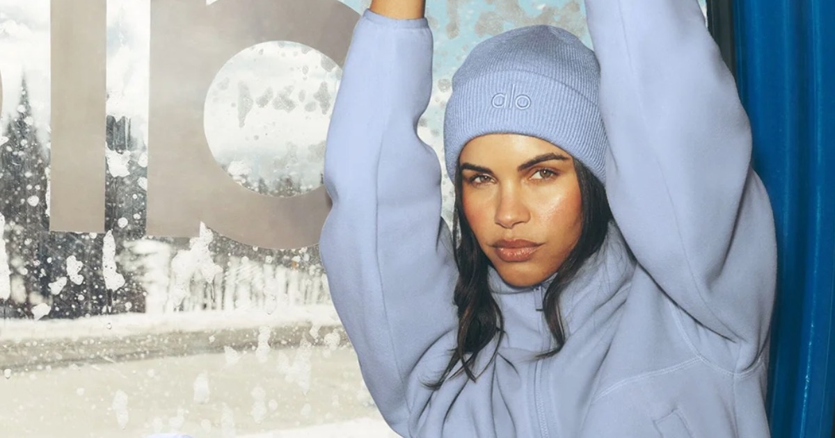 Model in a light purple beanie and fleece.