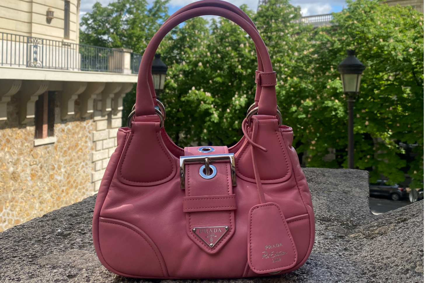 A photo of a pink Prada Re-Edition 2000 mini handbag