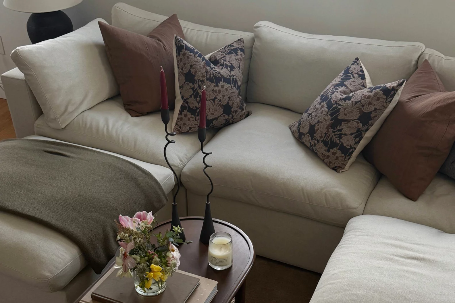 A white sofa with pillows.