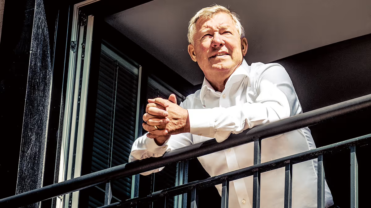 Image of Alex Ferguson leaning on a balcony.