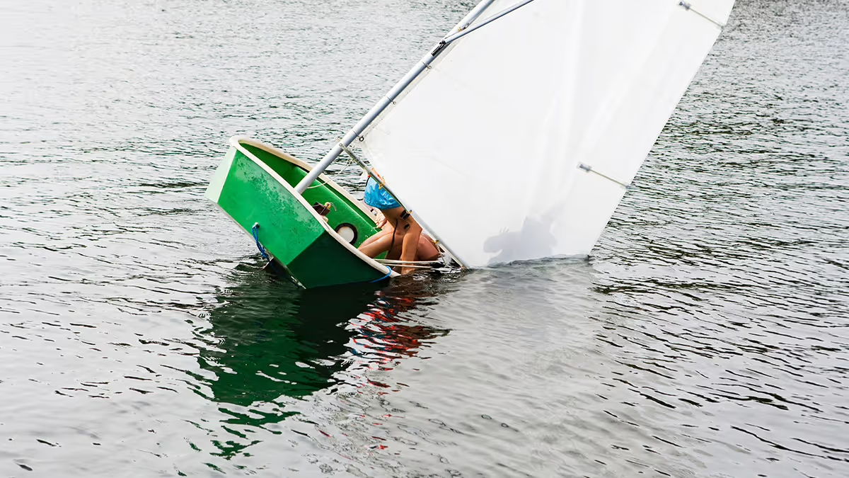 A picture of a sailboat starting to sink.