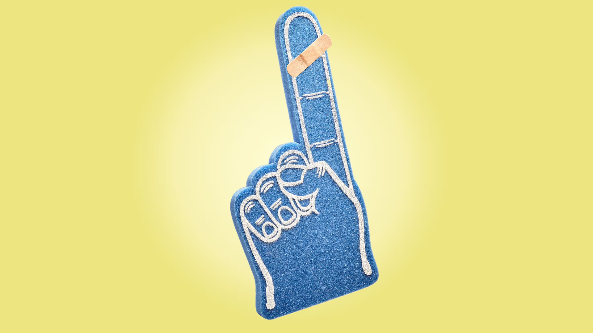 A big foam hand with a bandaid on the finger against a yellow background.