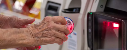 A customer uses a self-checkout machine while shopping at Albertsons in Arcadia in July 2023.
