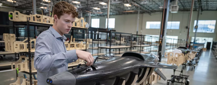 Ethan Thornton looks over a craft at Mach Industries headquarters.