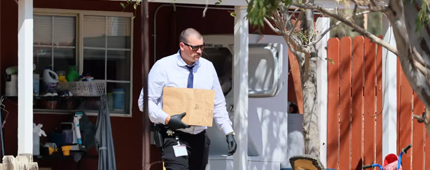Sheriff investigators carry package at the Cabazon home of 7-month-old Emmanuel Haro.