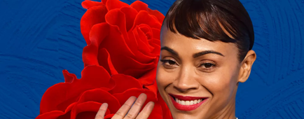 Zoe Saldana with roses next to her.