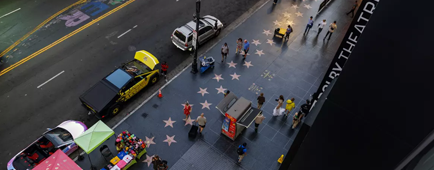 Tourists walk along Hollywood Boulevard in front of the Dolby Theater in L.A.