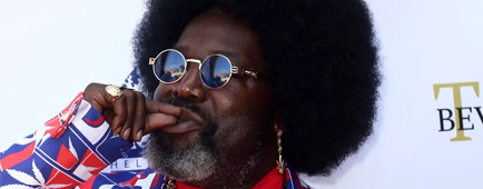 Afroman mimes smoking a joint as he poses for photos in a red, white and blue suit Afroman mimes smoking a joint as he poses for photos in a red, white and blue suit