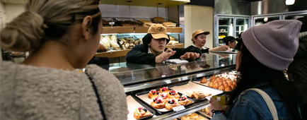Workers assist customers at the original Porto's Bakery in Glendale.