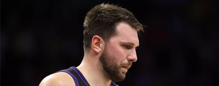 Lakers guard Luka Doncic stands on the court during a game. Lakers guard Luka Doncic stands on the court during a game.