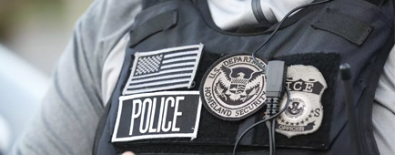 A U.S. Immigration and Customs Enforcement (ICE) agent in Los Angeles shown from the neck down to the arms. A U.S. Immigration and Customs Enforcement (ICE) agent in Los Angeles shown from the neck down to the arms.