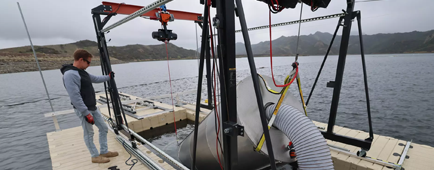 Mark Golay lowers a desalination "pod" into Las Virgenes Reservoir during testing by OceanWell.