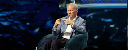 Eric Schmidt sits on a stage.