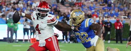 Utah quarterback Devon Dampier fends off UCLA linebacker Isaiah Chisom at the Rose Bowl.