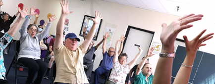 Marc Pierrat, center, who was diagnosed with frontotemporal dementia, exercises.  