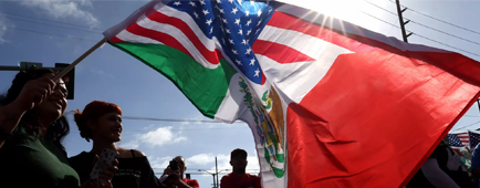 Someone waves a flag at a rally Someone waves a flag at a rally