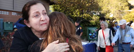 Palisades residents Mitra Lotfi, left, embraces Alicia Albek during the Annual Marquez Knolls Block Party.