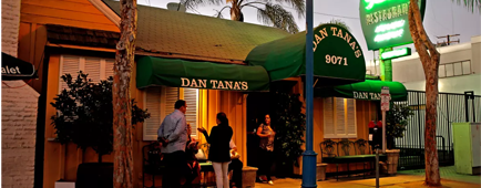 The exterior of Dan Tana's, with the neon sign glowing