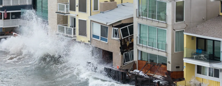 Waves crash into homes on the Alamitos Peninsula in Long Beach on Oct. 10.