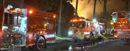 LAFD fire engines with flames in the background LAFD fire engines with flames in the background