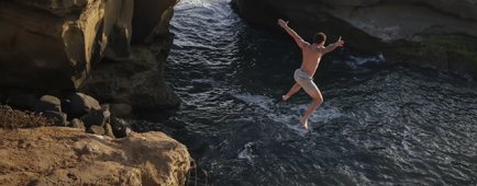 Marcus English jumps into the water at Sunset Cliffs in the Ocean Beach area of San Diego on Aug. 14.