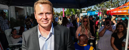 Spencer Pratt wears a collared shirt and suit at a block party