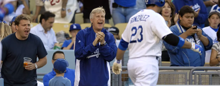 Los Angeles Dodgers owner Mark Walter, center, cheers at a Dodgers game in 2013.  