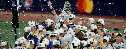 Dodgers players wear championship T-shirts and embrace under a shower of confetti. Dodgers players wear championship T-shirts and embrace under a shower of confetti.