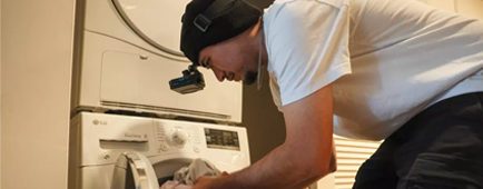 Salvador Arciga records himself placing clothes into a washing machine