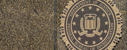 A seal that says "Department of Justice" on a wall.