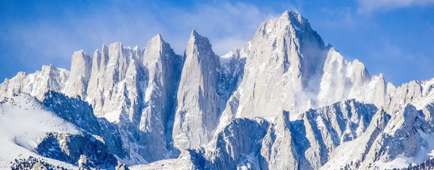 Snow blankets mountain peaks.