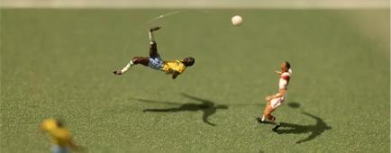 Miniature soccer players in a museum exhibition.