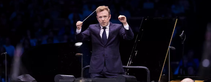 A man conducts and orchestra.